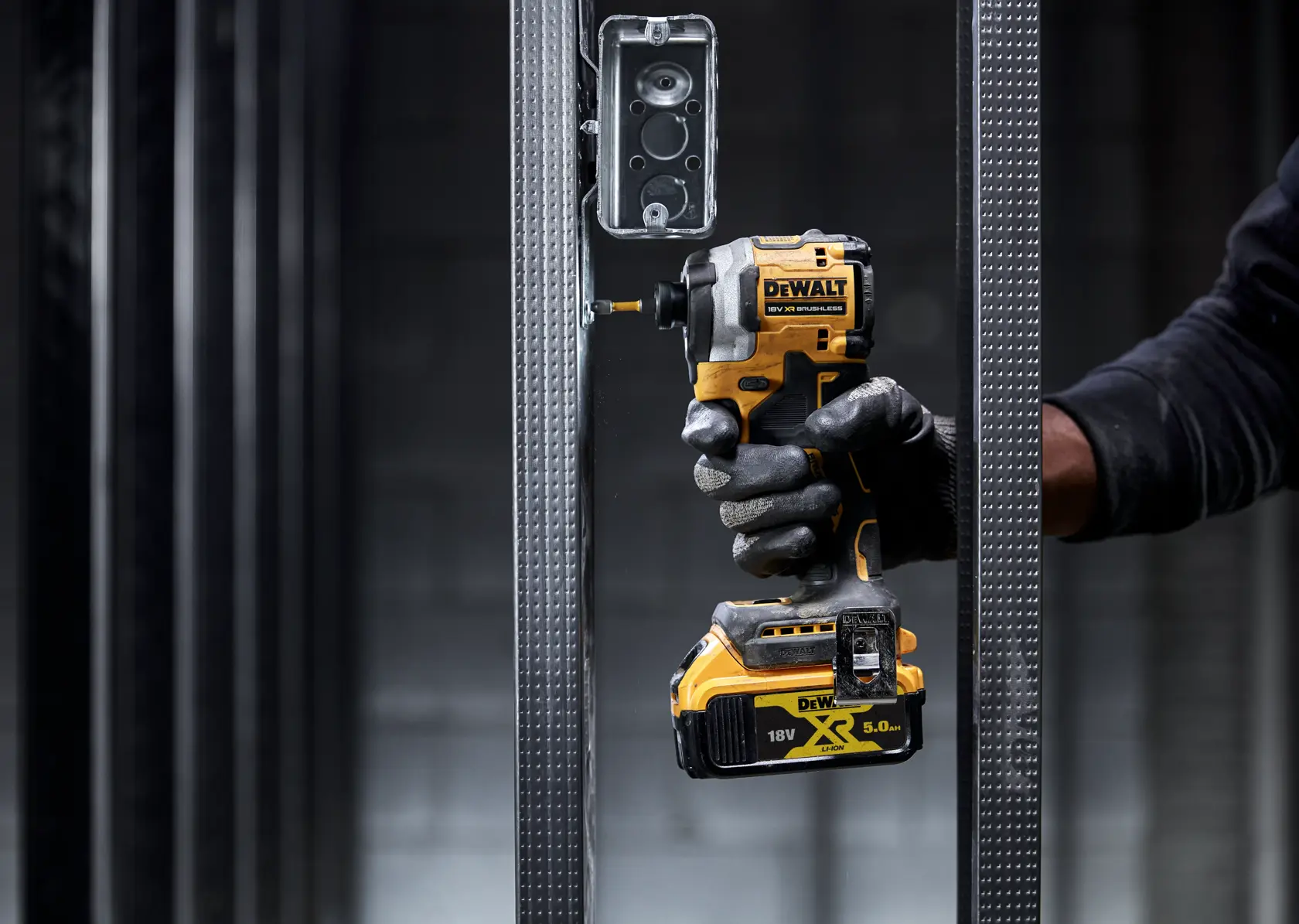 DEWALT tool in use. Shown: DCF850N, DCZ2050P2T-XE, DCZ401P3-XE. Compact cordless driver for construction jobs.