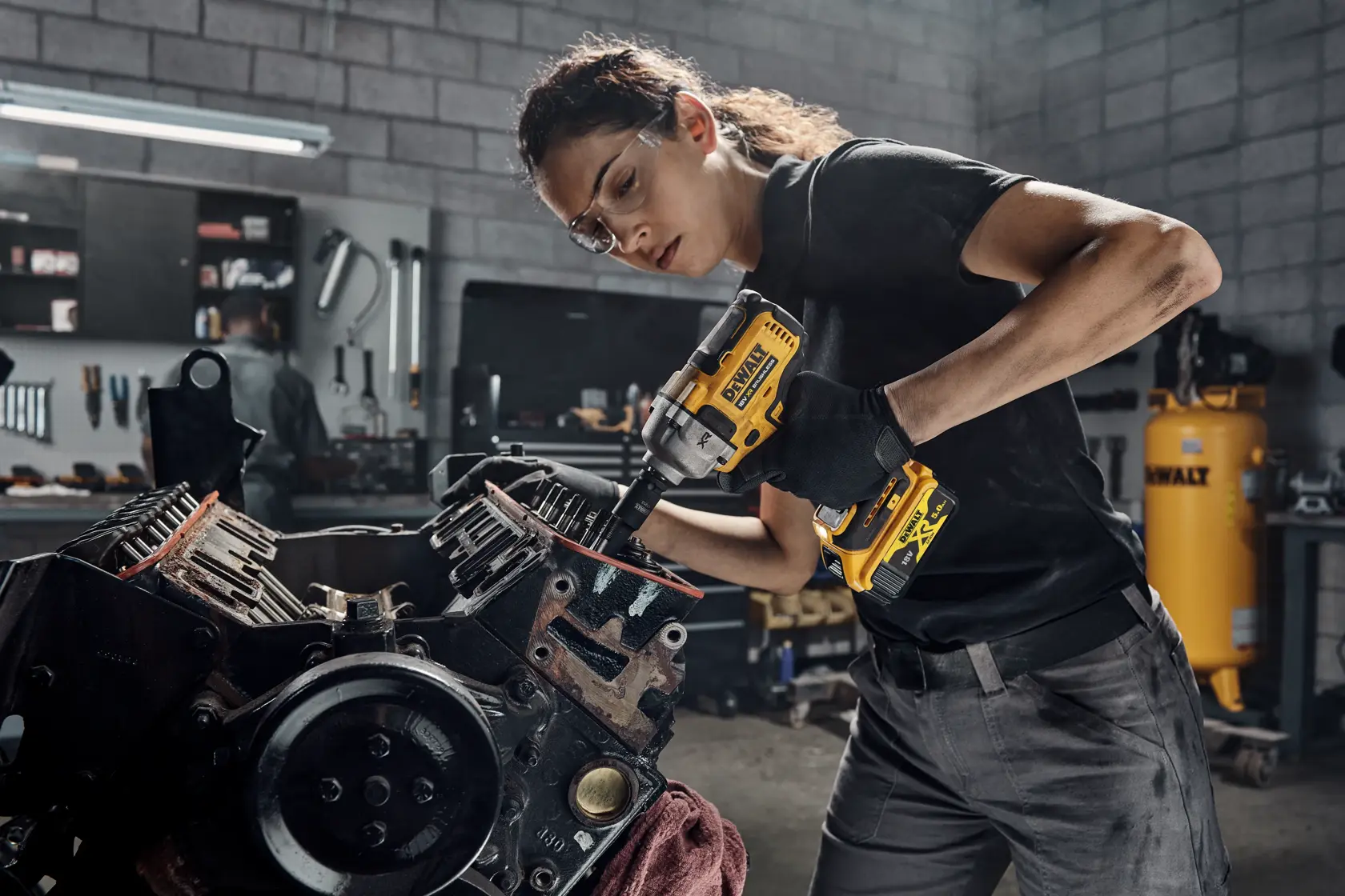 DEWALT DCF892N, DCZ407P1T1-XE tools used on engine in workshop. Photography product category.