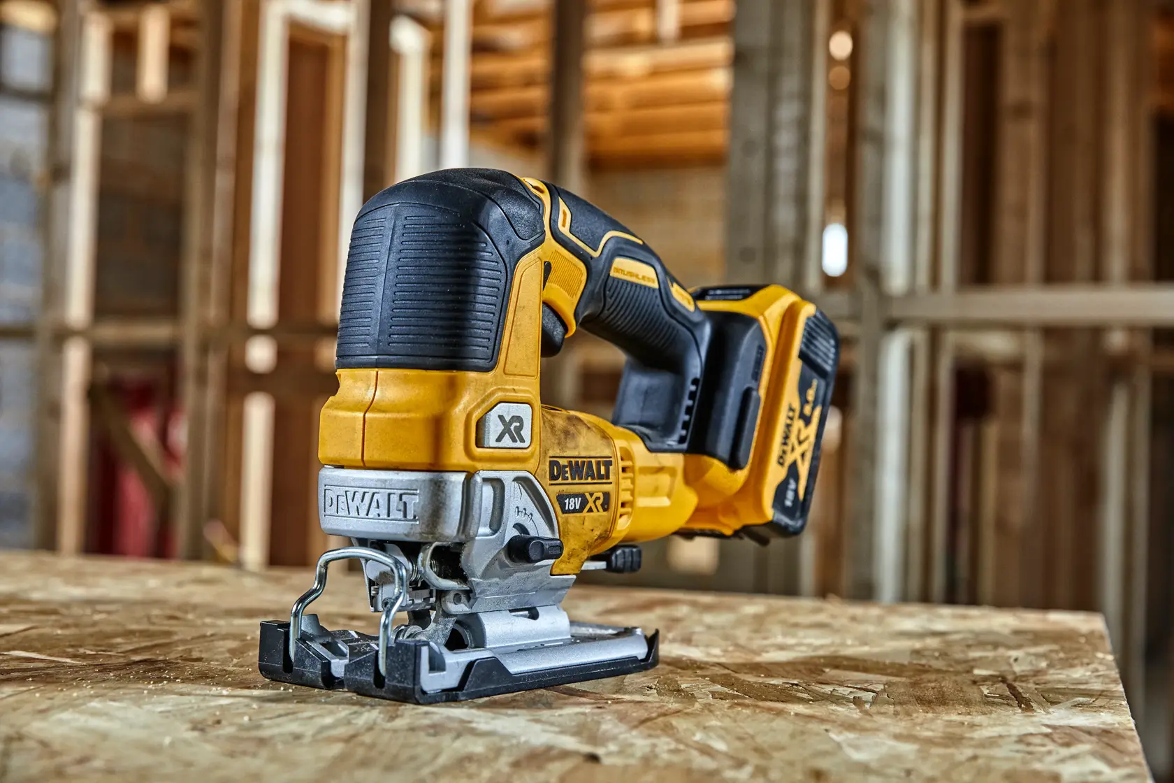 DEWALT cordless jigsaw on wooden surface in workshop.