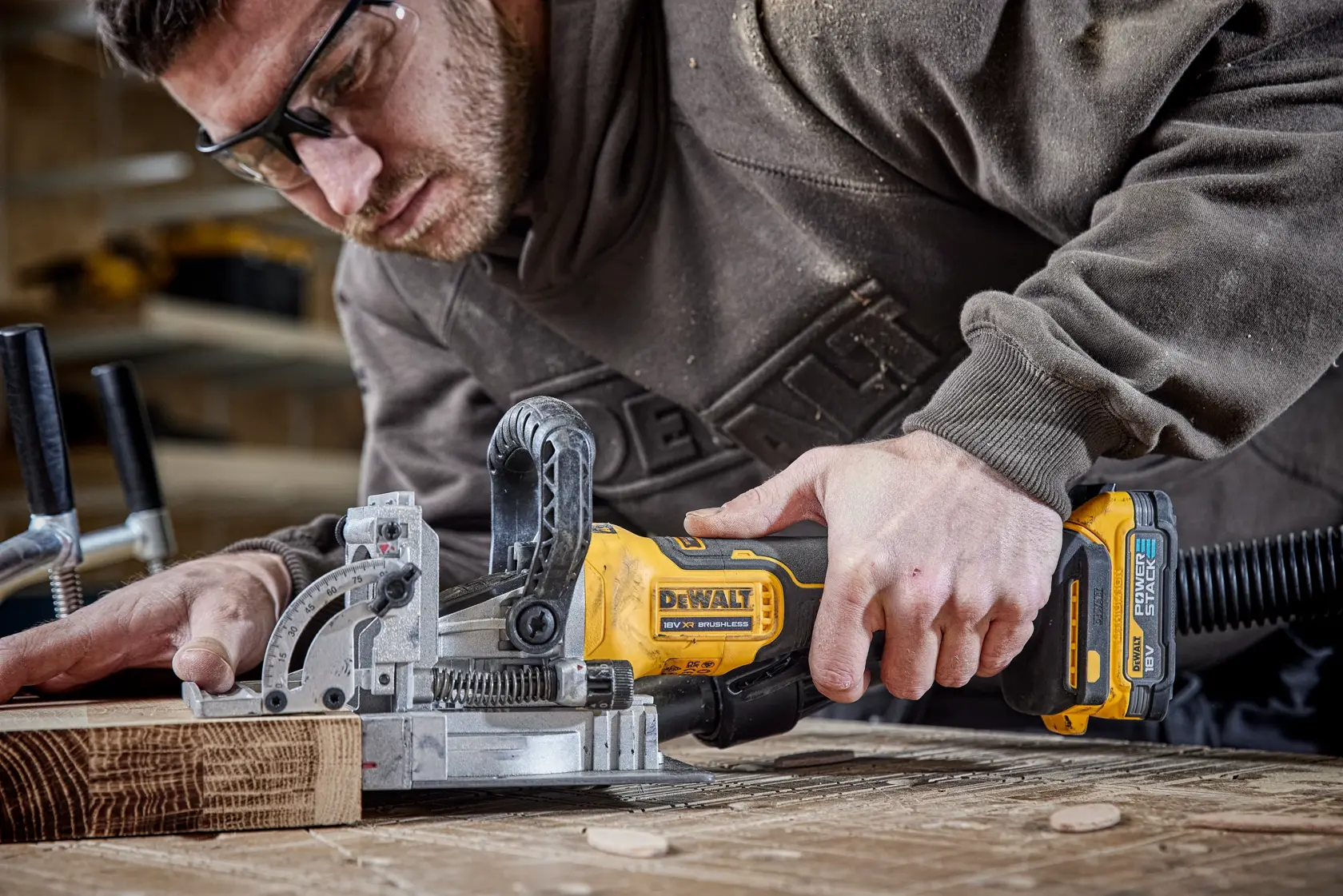 DEWALT tool used on wood, shown with DCW682P2-QW and DCW682P2 SKUs in workshop setting.