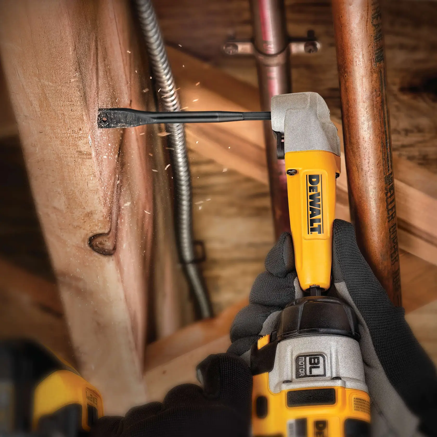 DEWALT drill with wood flat bit drilling through wooden beam, sparks flying, worker wears black gloves.