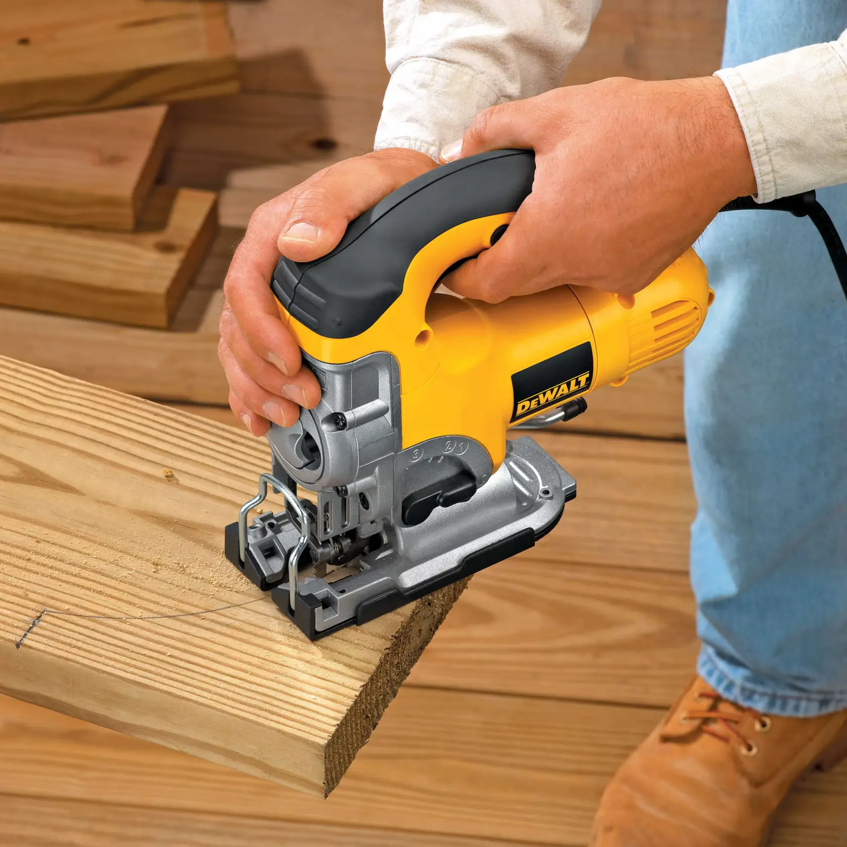 A person using a yellow and black DEWALT jigsaw to cut a countertop. The tool is plugged in and held firmly for precise cutting.
